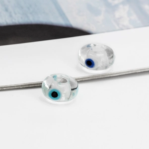Macro shot of transparent Evil Eye resin beads for DIY jewelry making and necklace crafts