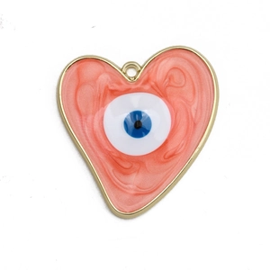 Macro detail of a heart-shaped Evil Eye DIY pendant with pink enamel and gold-plated alloy