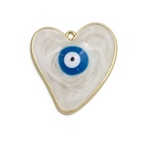 Macro detail of heart-shaped evil eye pendant with golden metal edges and marble texture