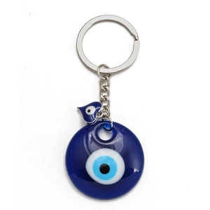 Close-up of blue Nazar Evil Eye glass charm with silver metal keychain and heart pendant