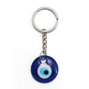 Macro detail of Turkish blue evil eye keychain with polished resin ring and silver metal clasp