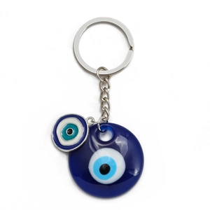 Detail of blue evil eye keychain with two resin charms and polished silver metal ring