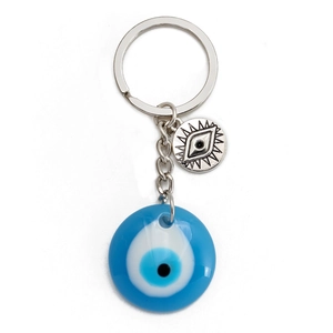 Detailed macro view of the silver metal charm and blue resin Evil Eye on keychain