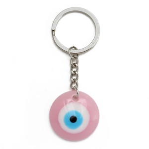 Detailed macro view of a pink Evil Eye resin pendant with silver metallic keychain ring
