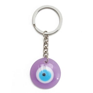 Detail of a purple translucent resin Evil Eye keychain with blue eye design and silver ring