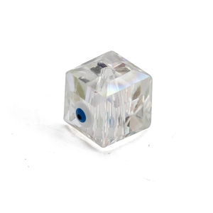 Detail of faceted transparent cube bead with blue evil eye inlay for jewelry making