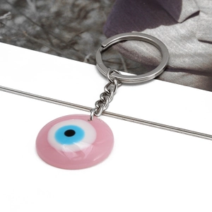 Pink Evil Eye keychain with resin pendant and silver metal ring on white background