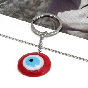 Red Evil Eye keychain pendant with silver metal ring and resin bead detail
