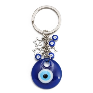 Macro shot of blue Evil Eye keychain with resin pendants and silver metal star charms