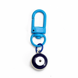 Detail of blue Evil Eye Nazar pendant with gold metal trim and light blue lobster clasp