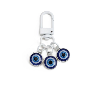 Detail of blue Evil Eye keychain with white lobster clasp and sparkling glitter accents