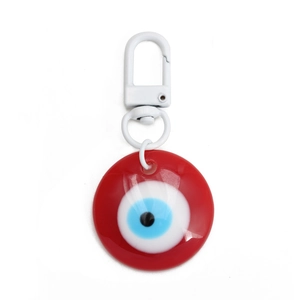 Detail of red evil eye keychain with matte white lobster clasp on white background