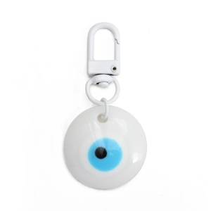 Close-up of white resin Evil Eye charm with blue pupil and matching white metal hook