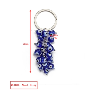 Detail view of Evil Eye keychain with blue glass beads and 90mm length specifications