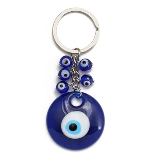 Detail of blue evil eye keychain with glass beads and polished silver metal ring