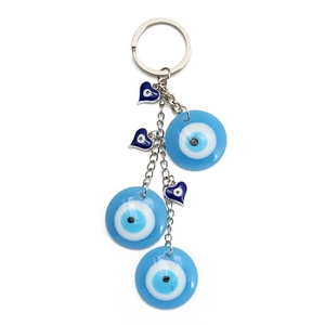Blue evil eye keychain with glass beads and metal rings on a white background