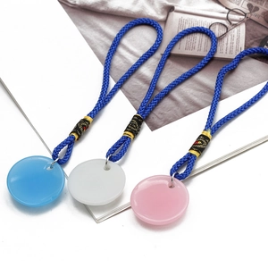 Detailed macro view of three colorful evil eye resin pendants with hand-braided ropes
