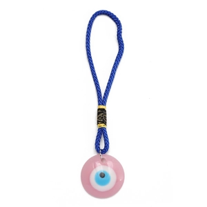 Close-up of a pink Evil Eye charm with light blue beads and a dark blue woven cord
