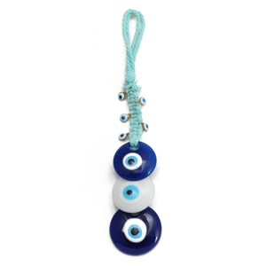 Detail of Turkish evil eye wall hanging with woven cord and blue glass amulets