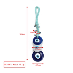 Detail showing dimensions of blue Evil Eye keychain pendant with glass beads and woven cord