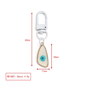 Detail view of evil eye palm keychain with specific product dimensions and weight specs