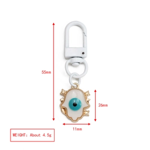 Detailed view of Hamsa and Evil Eye keychain showing specific dimensions and weight details