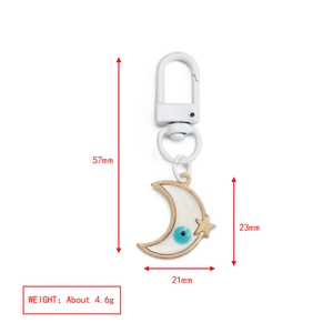 Detailed size measurement of moon-shaped evil eye pendant keychain with white enamel