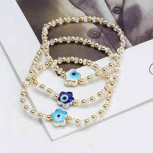 Set de 3 bracelets en perles dorées et cristal avec pendentifs fleurs Mauvais Oeil