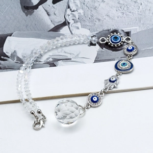 Detailed view of evil eye car charm with faceted glass beads and a crystal ball pendant