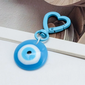 Detail view of Evil Eye charm with blue heart clip and protective glass bead pendant