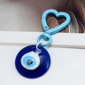 Detail of blue Evil Eye keychain with a heart-shaped clip and resin nazar charm pendant