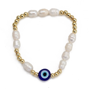 Handmade Evil Eye bracelet with baroque pearls and gold beads on a white background