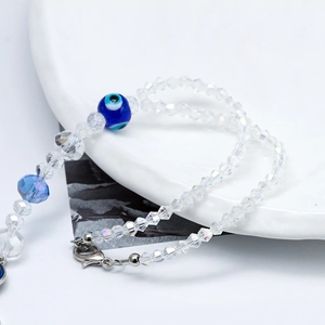 Detail of beaded evil eye bracelet with faceted clear crystal beads and lobster clasp