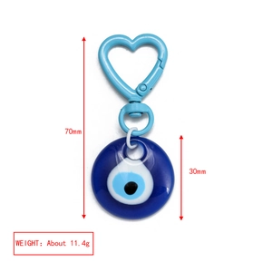 Detail view of heart-shaped evil eye keychain with blue enamel finish and dimensions shown