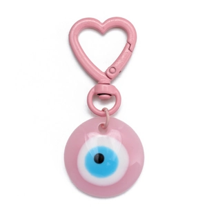 Close-up of pink heart-shaped carabiner with a colorful evil eye enamel pendant