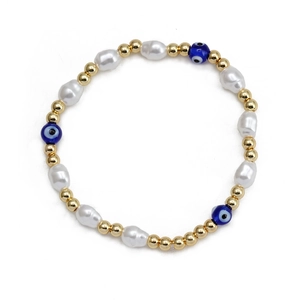 Detail of baroque pearls and blue evil eye beads on a golden beaded elastic bracelet
