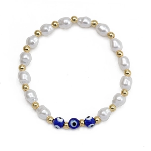 Detailed close-up of Baroque pearl evil eye beaded bracelet with gold accents on white