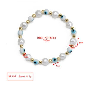 Detail view of evil eye elastic bracelet with 8mm pearls and size measurements