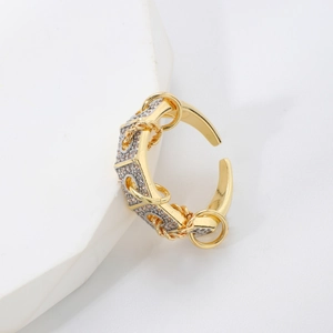 Detailed close-up of a two-tone geometric open ring with gold accents and zircon inlay