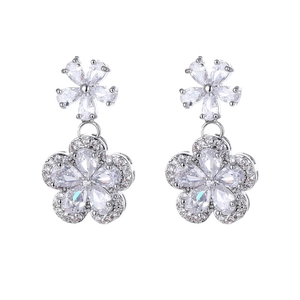 Detail of silver plum blossom drop earrings featuring micro-set zircon crystals