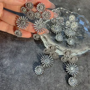 Detail of silver long tassel drop earrings with sparkling sunflower zircon petals
