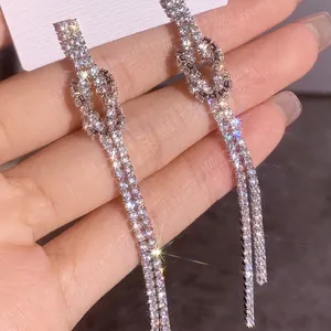 Elegant long tassel earrings with sparkling knot design and shimmering rhinestones
