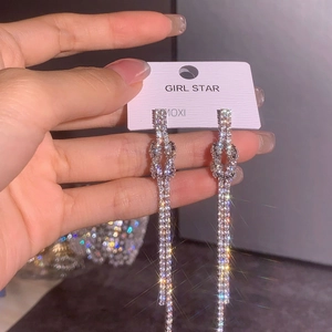 Elegant long tassel drop earrings with sparkling woven knot and silver rhinestone fringe