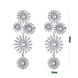 Detail view of silver drop earrings with floral zircon clusters measuring 54mm by 22mm