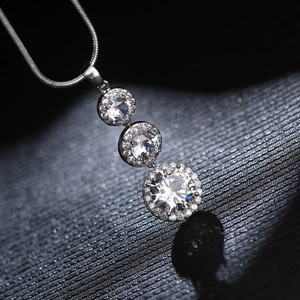 Elegant silver pendant necklace with three tiered circular diamonds on a sleek snake chain