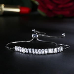 Macro shot of silver adjustable bracelet with rectangular cubic zirconia in romantic setting