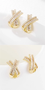 Detail of gold geometric cross earrings with baguette and round cubic zirconia stones