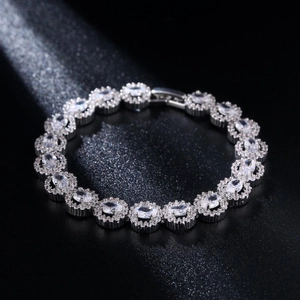 Bracciale in argento a cuore cavo con zirconi halo ovali su sfondo nero elegante
