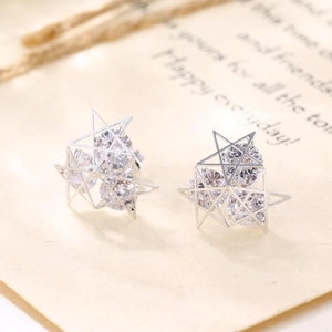 Stereo hollow star stud earrings with sparkling cubic zirconia in silver metal