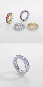 Close-up macro of oval cut eternity rings with four-prong settings in gold and silver